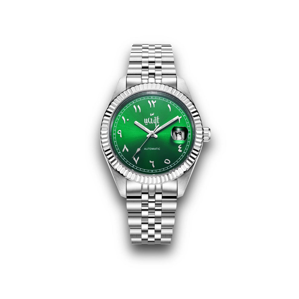 Front view of the Waqt Emerald Green watch featuring a deep green dial with silver Arabic numerals, fluted bezel, and stainless steel case, highlighting its bold and elegant design